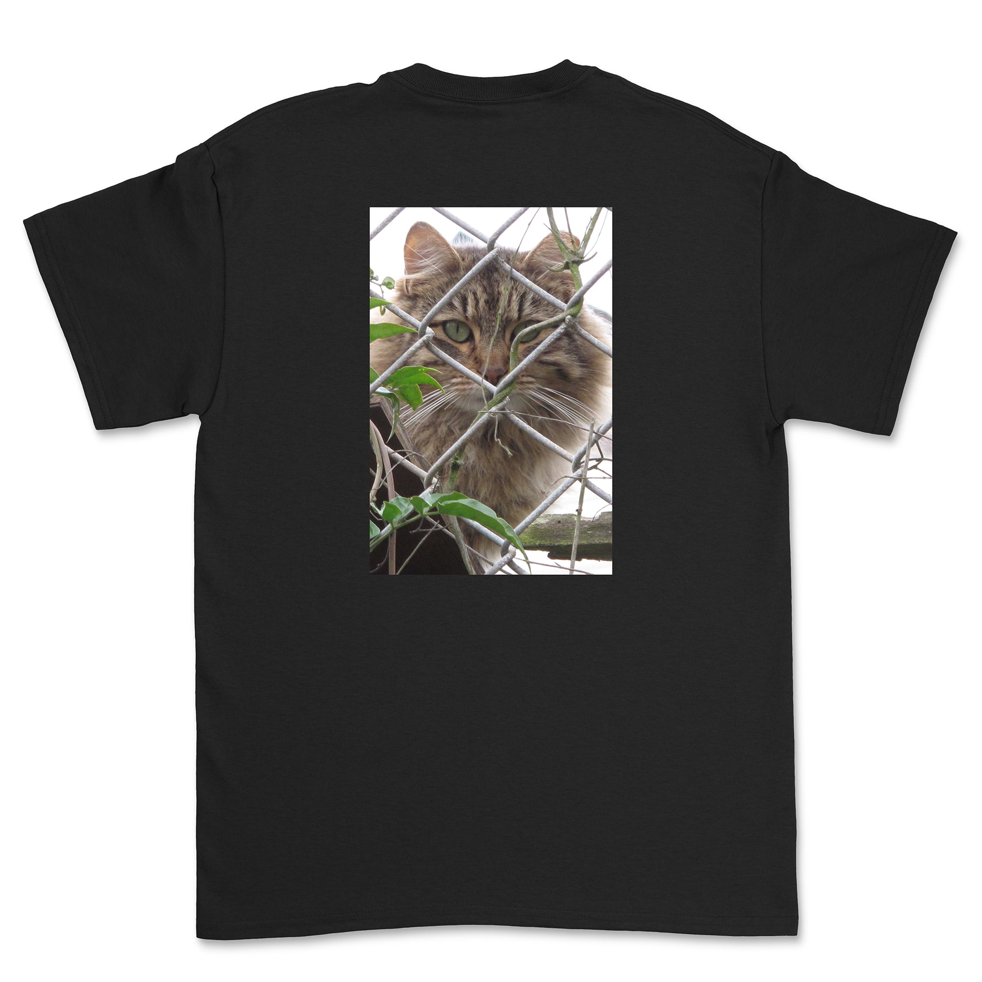 Black t-shirt with a cat behind a chain-link fence on the back