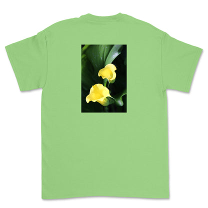 Green t-shirt with a graphic of two yellow flowers on a white background
