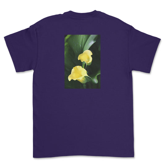 Purple t-shirt with a graphic of two yellow flowers on a white background